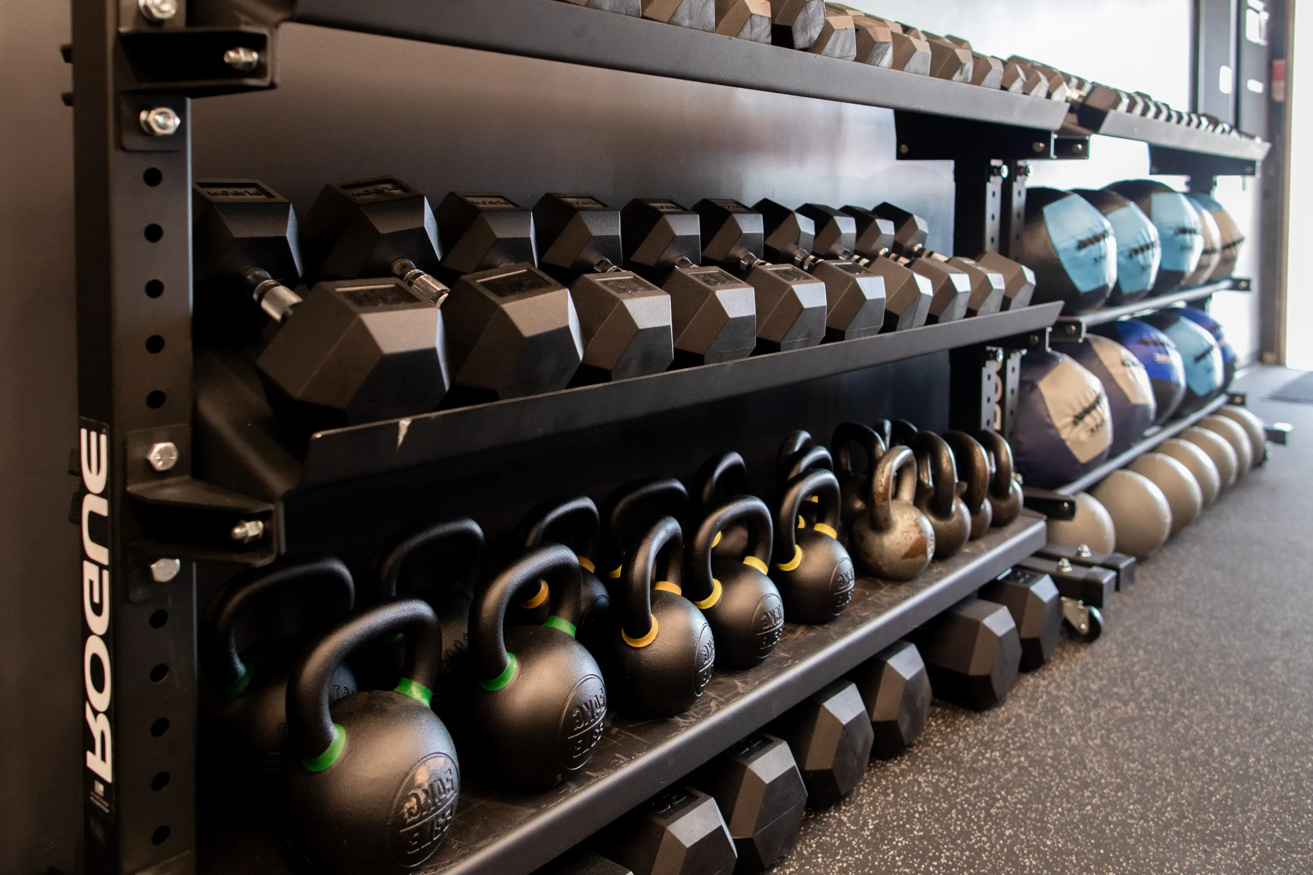 Rack of kettlebells and dumbbells at The Cove